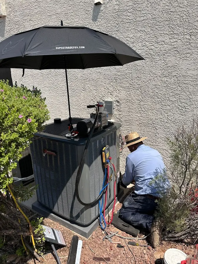 HVAC technician performing outdoor AC maintenance in Barnesville